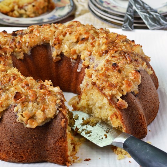 An intensely moist and sweet gluten free pineapple coconut bundt cake topped with a broiled brown sugar, coconut, and macadamia frosting for the perfect crunch.