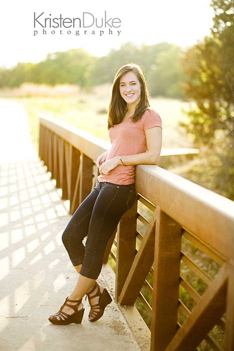 senior picture leaning against a bridge