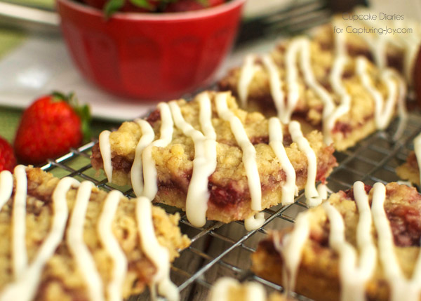 Strawberry Crumb Bars - Crispy cookie crust with a sweet strawberry layer, buttery crumble, and white chocolate glaze. A perfect treat for summer!
