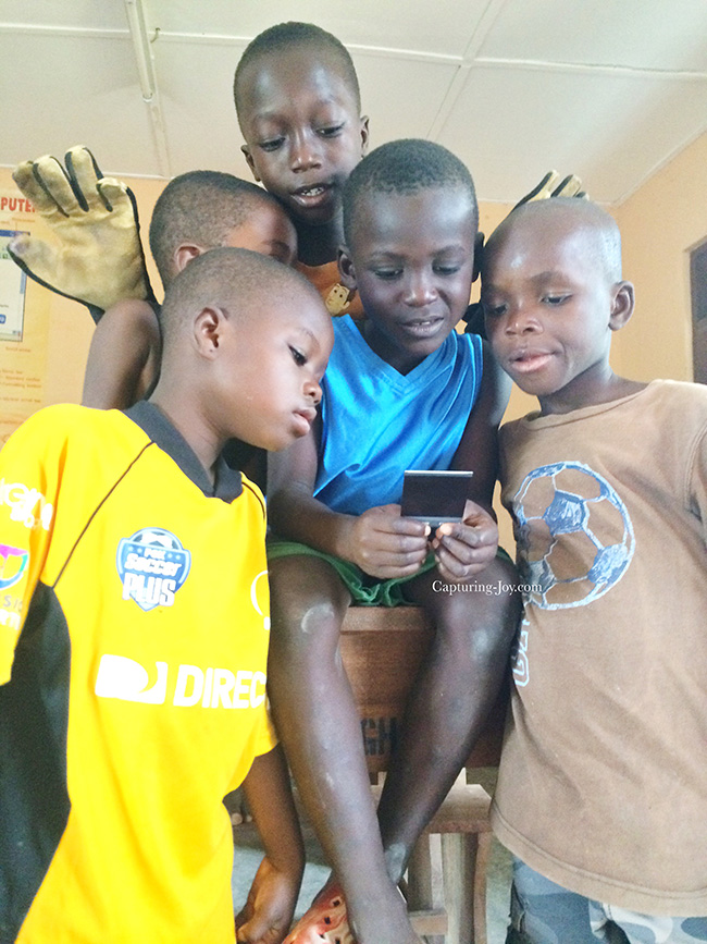 Ghanaian children checking out instant picture