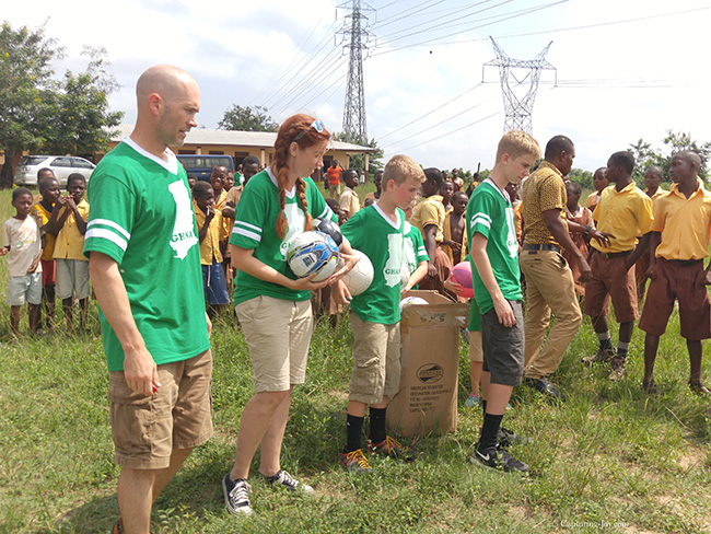 presenting soccer supplies to Ghana school