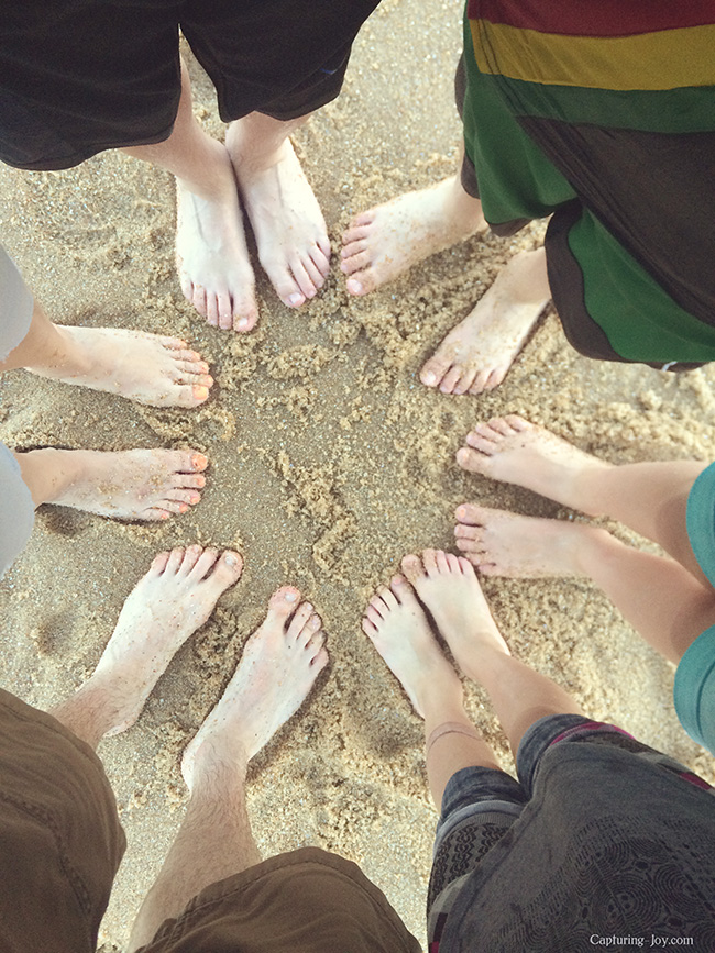 family feet in the sand