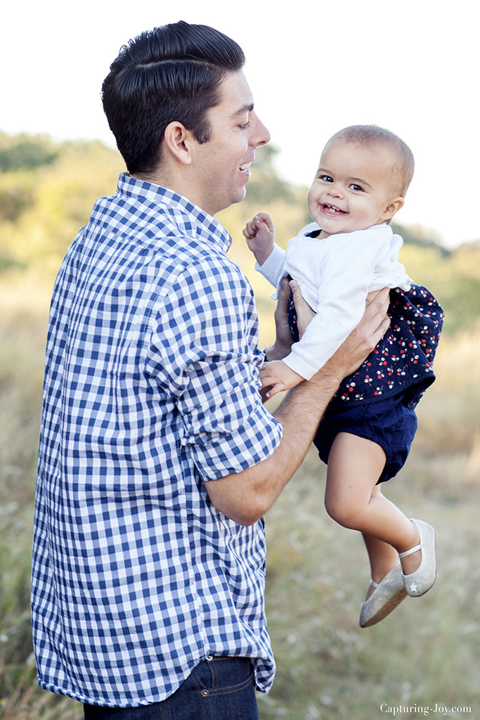 Family photo session with one year old baby in orange and navy blue clothes