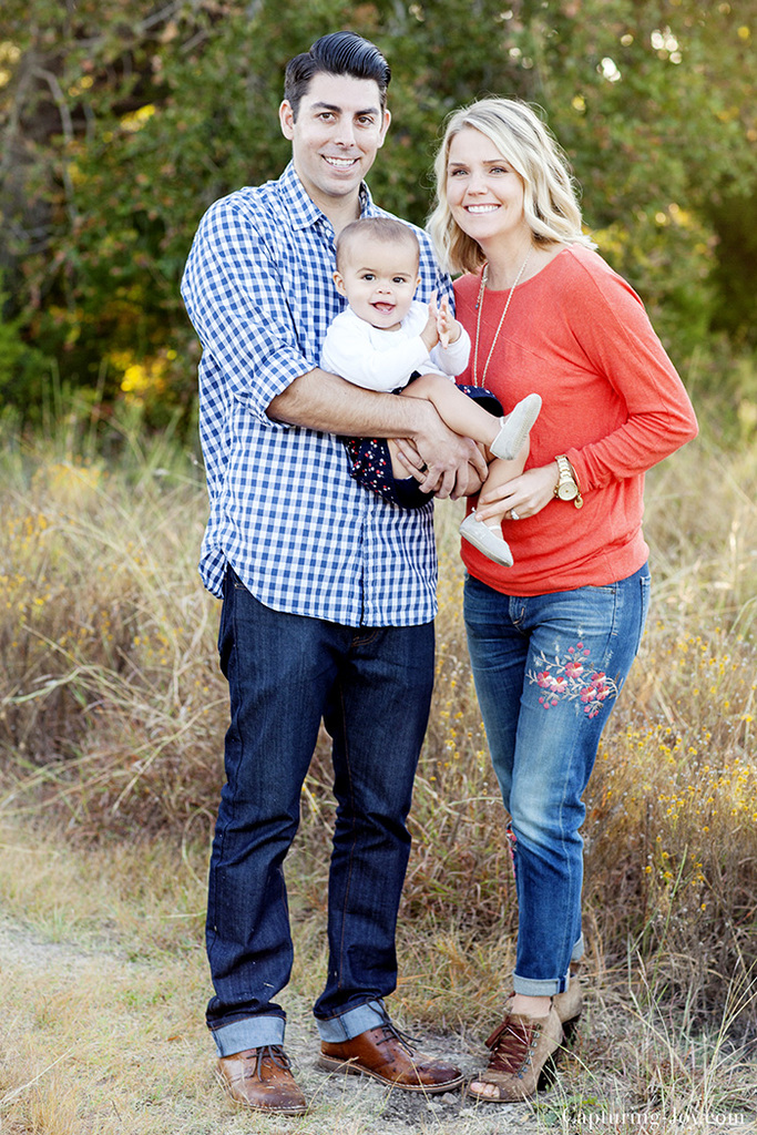 Family photo session with one year old baby in orange and navy blue clothes