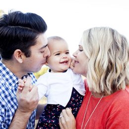 Family photo session with one year old baby in orange and navy blue clothes